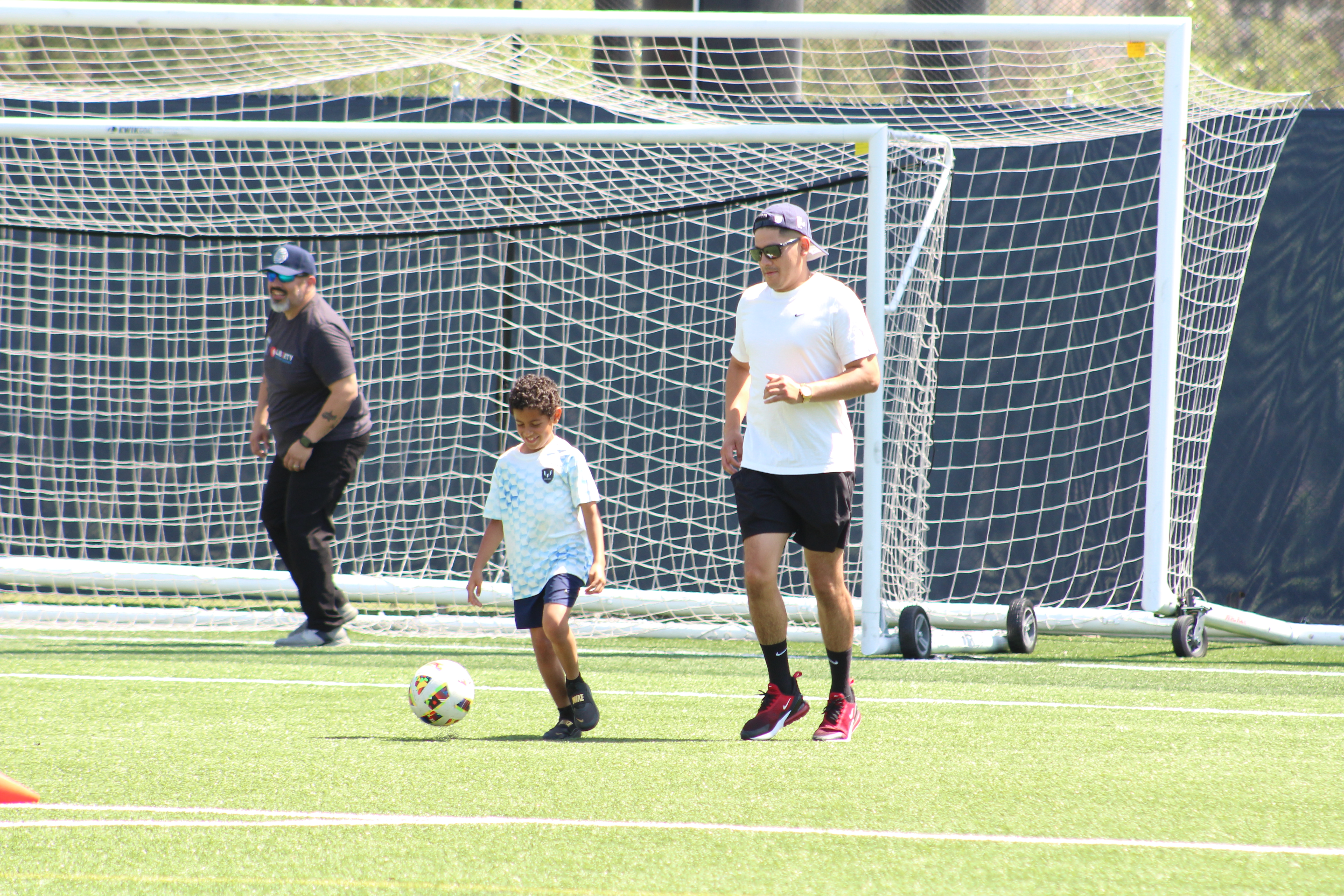 Kid and adults playing soccer