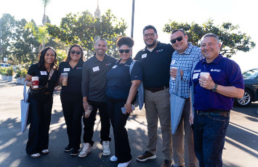 A group of colleagues standing outside together.