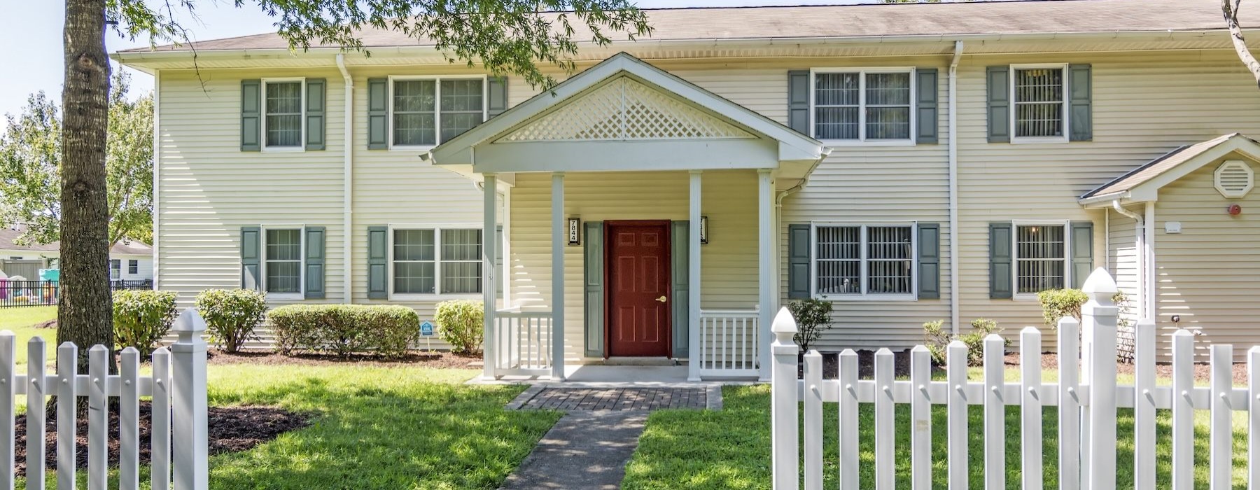 a house with a porch and red door