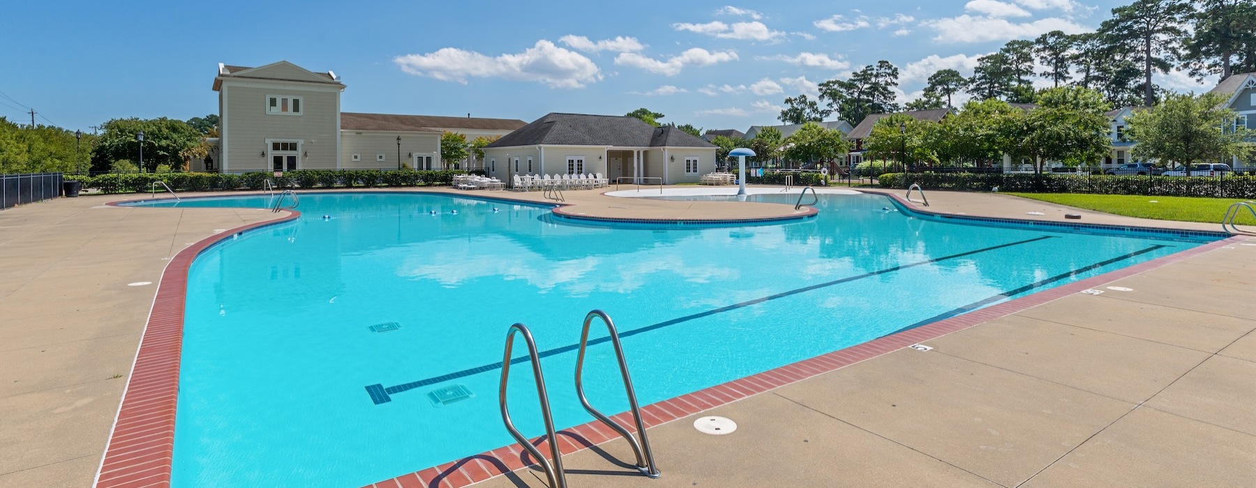 Resort-style swimming pool with lounge seating