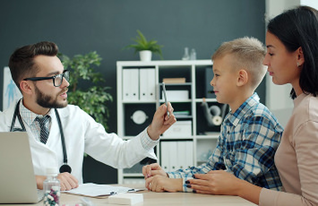 Doctor examining a young boy during a medical checkup.