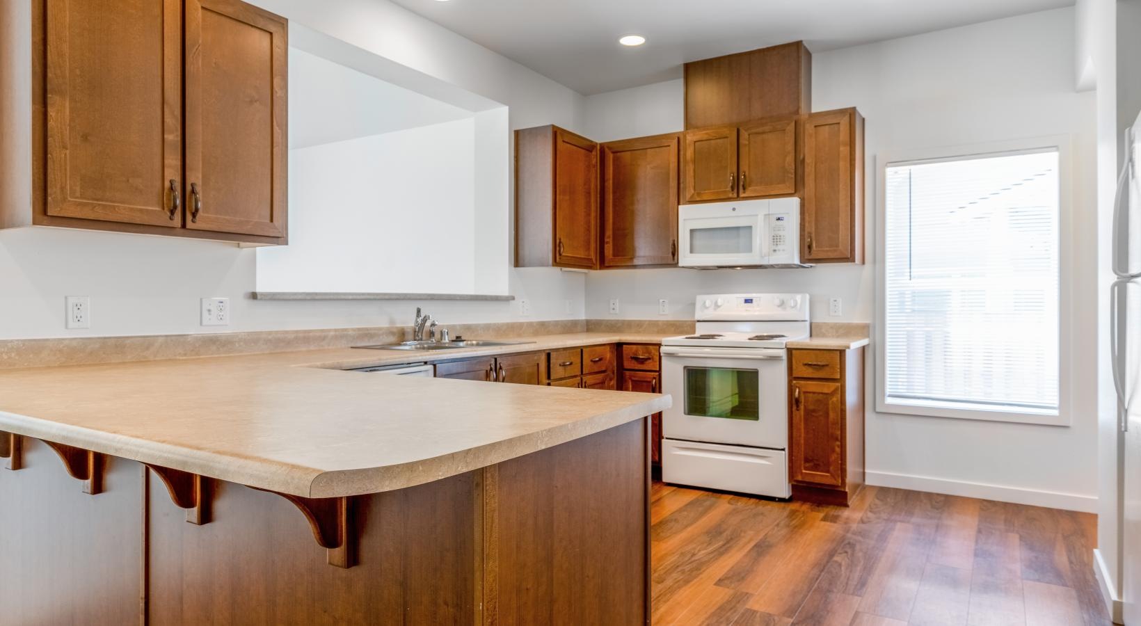 a kitchen with wooden cabinets