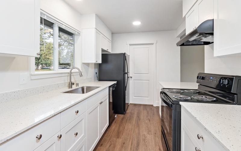 a kitchen with white cabinets