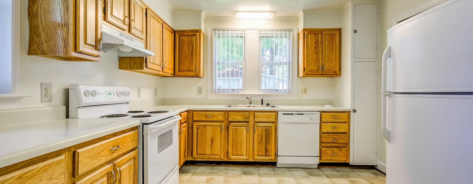 kitchen with wooden cabinets and white appliances
