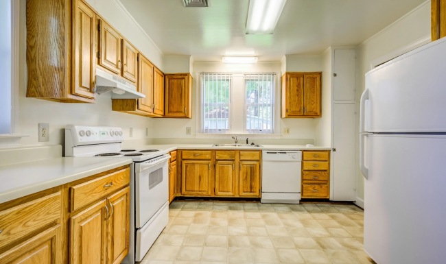 kitchen with wooden cabinets and white appliances