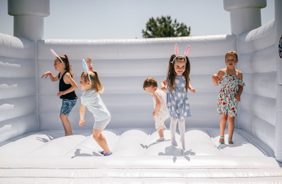 kids jumping on a bounce house 