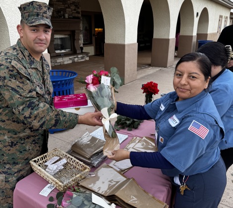 Liberty Team Member Handing Out roses to Military Member 