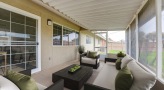 screened patio with a table , chairs and couch