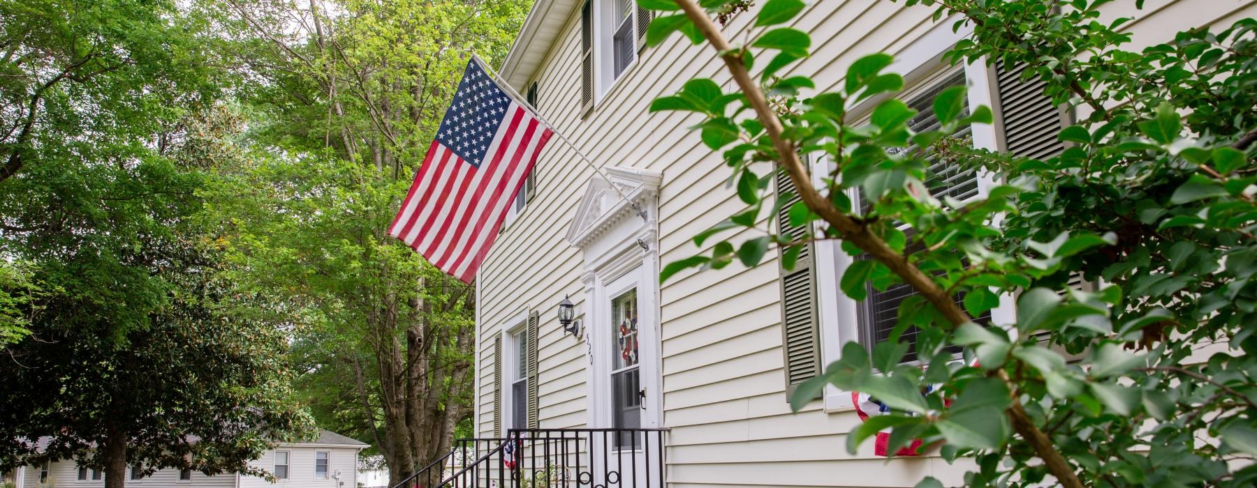 a house with a flag on the porch