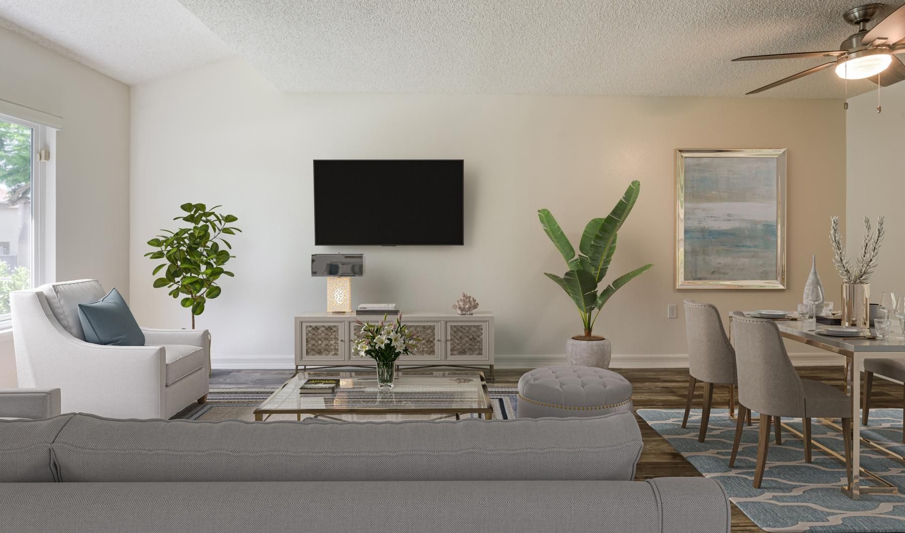 a living room with a tv and chairs