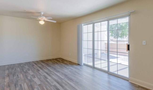 a room with a wood floor and a glass door