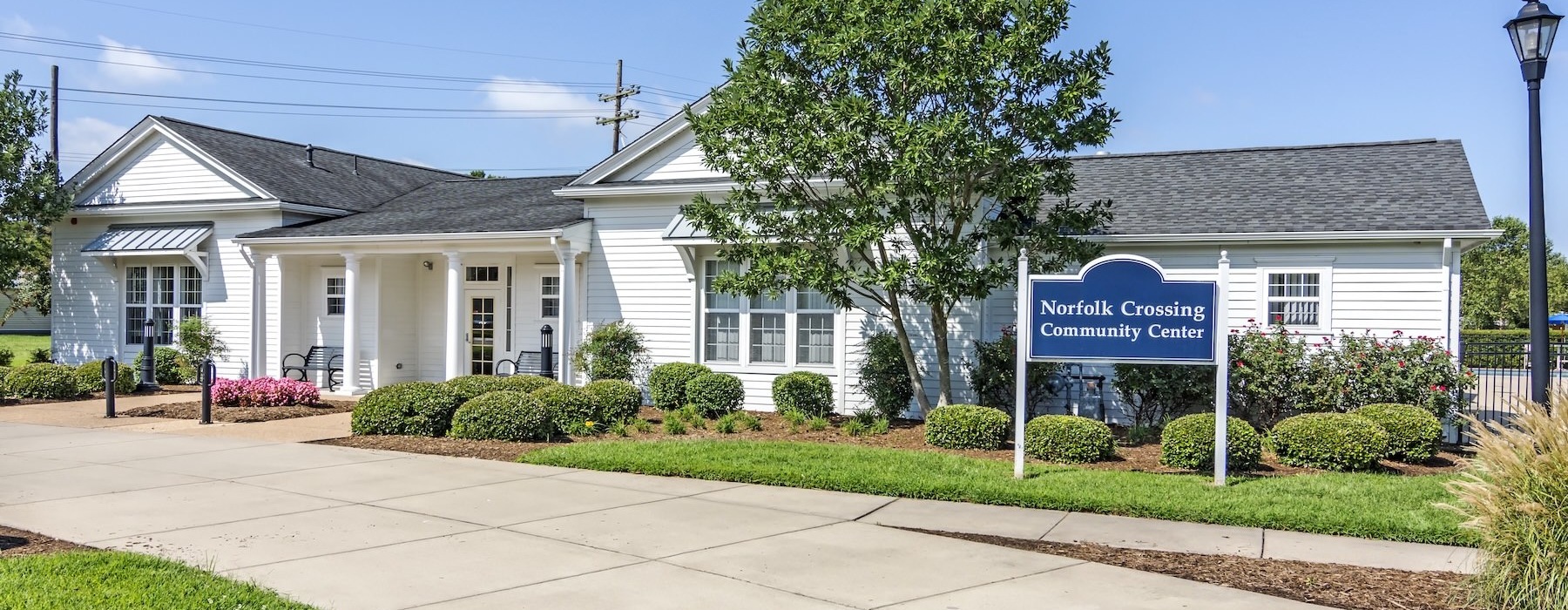 community center exterior with a blue sign in front of the entrance