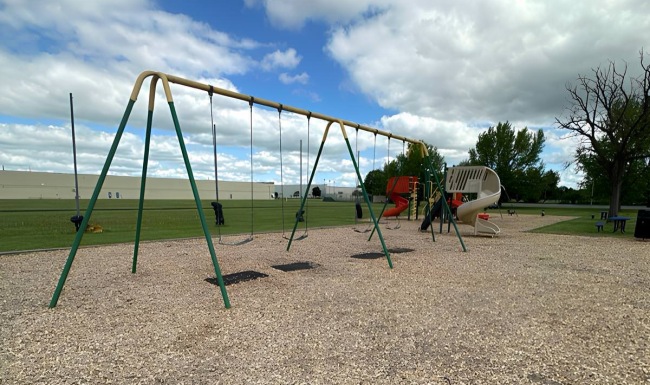 a playground with a slide and swings