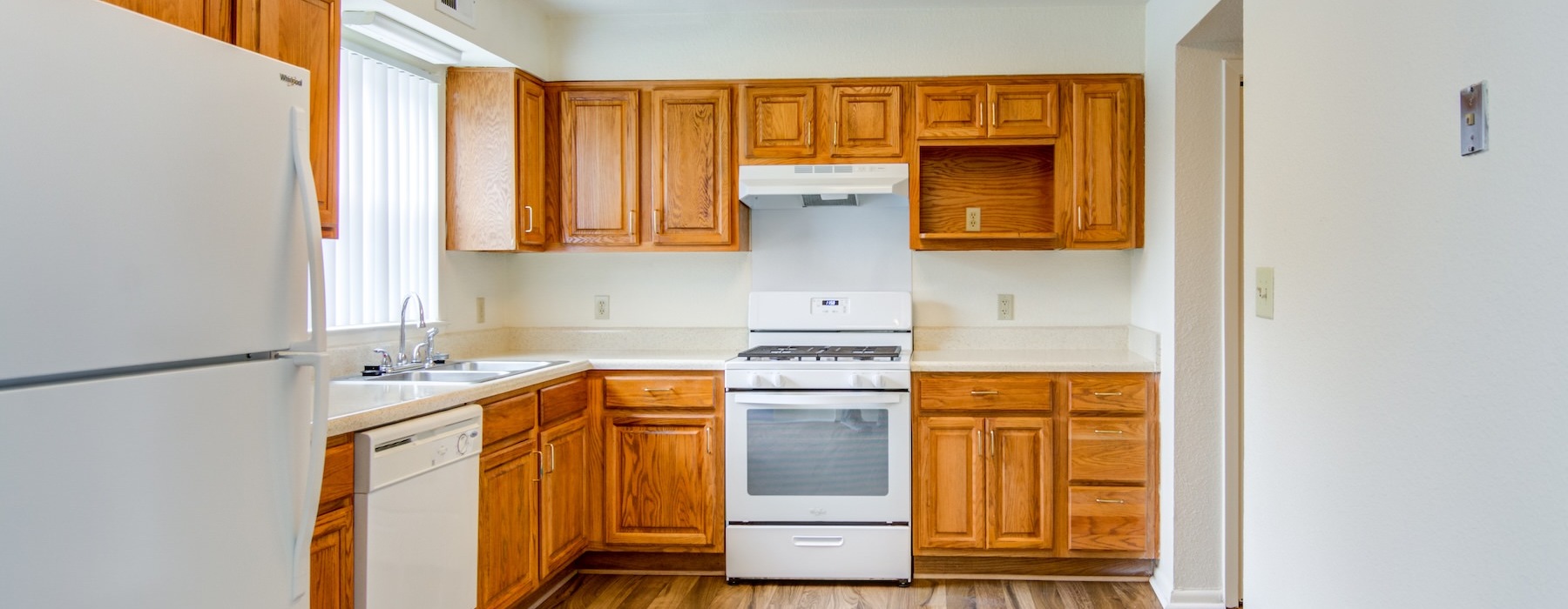 kitchen with wooden cabinets and white appliances