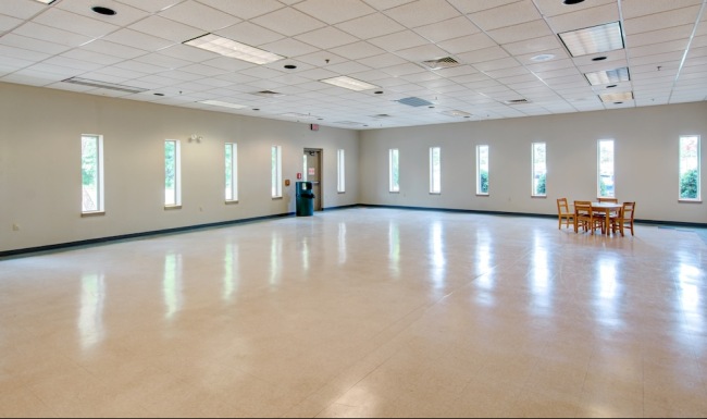 an empty room with windows and a table
