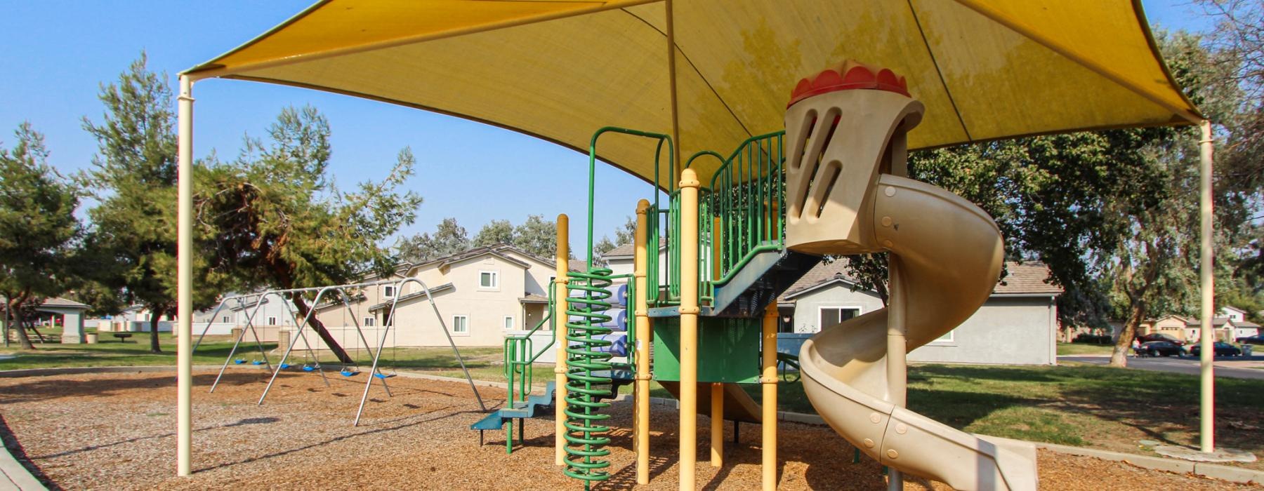 a playground with a slide and a slide