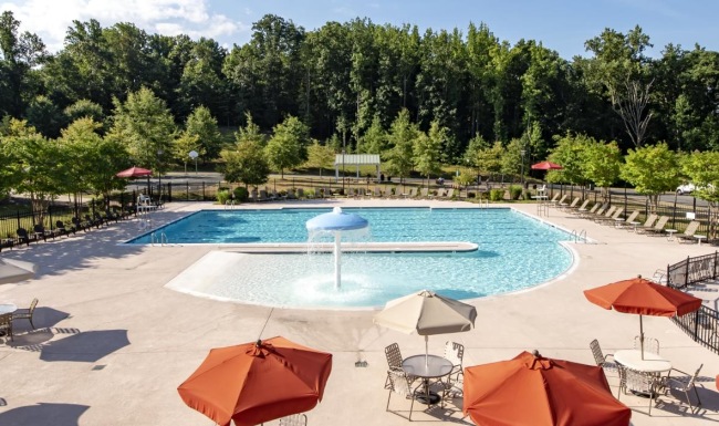 a pool with umbrellas and chairs next to it
