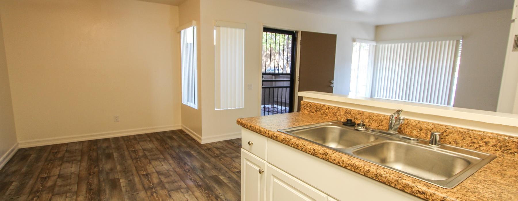a large kitchen with wood-style floors and a double basin sink