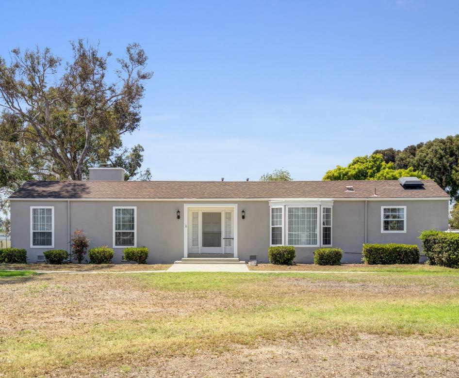 a house with a lawn and trees