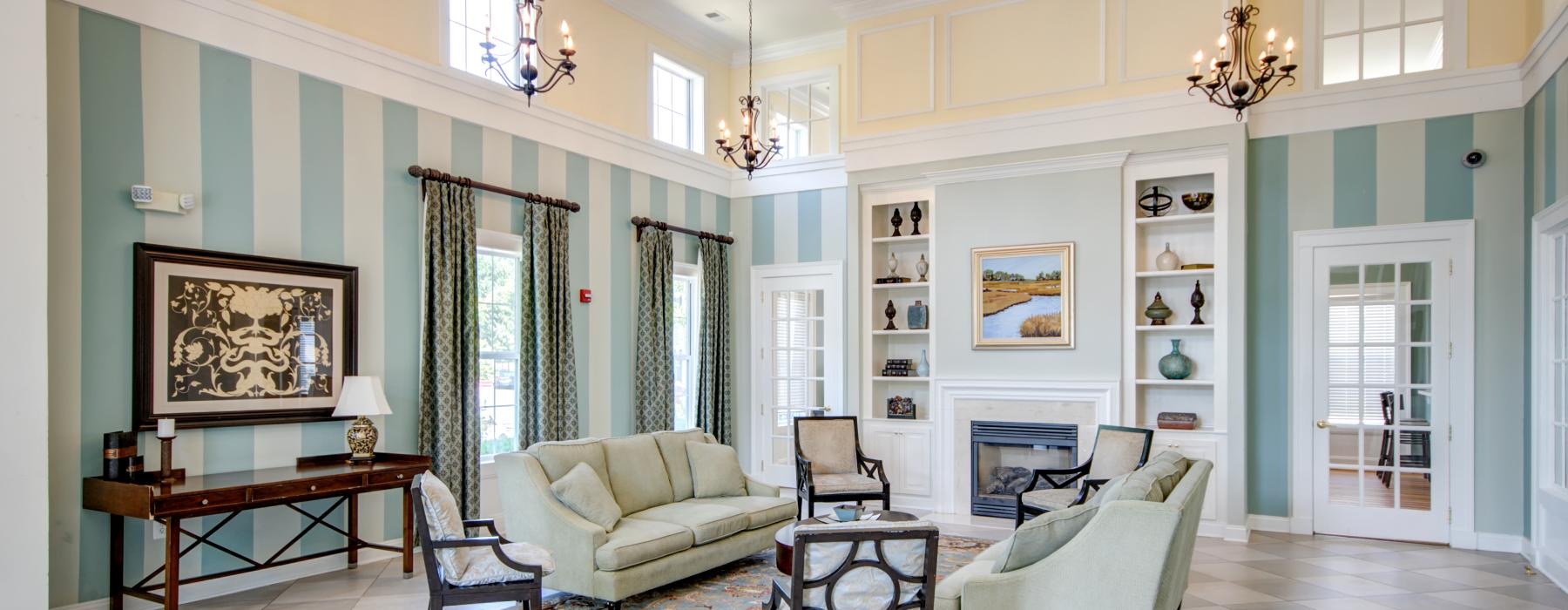 a club room with a chandelier and a couch