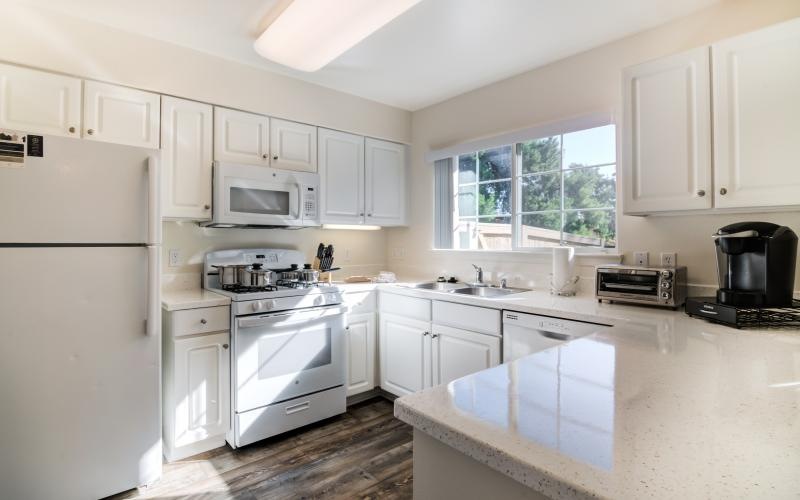 a kitchen with white cabinets