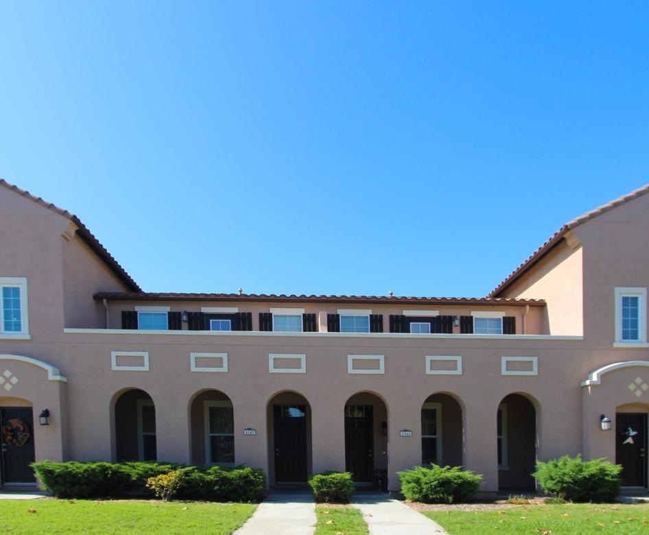 a large building with a lawn in front of it