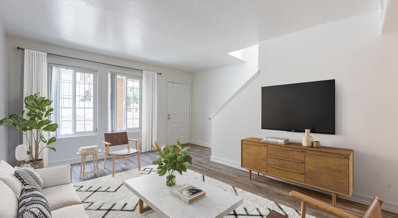 a living room with a tv and furniture