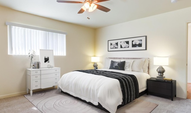 a bedroom with a ceiling fan