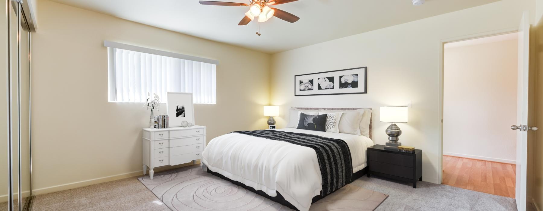 a bedroom with a ceiling fan