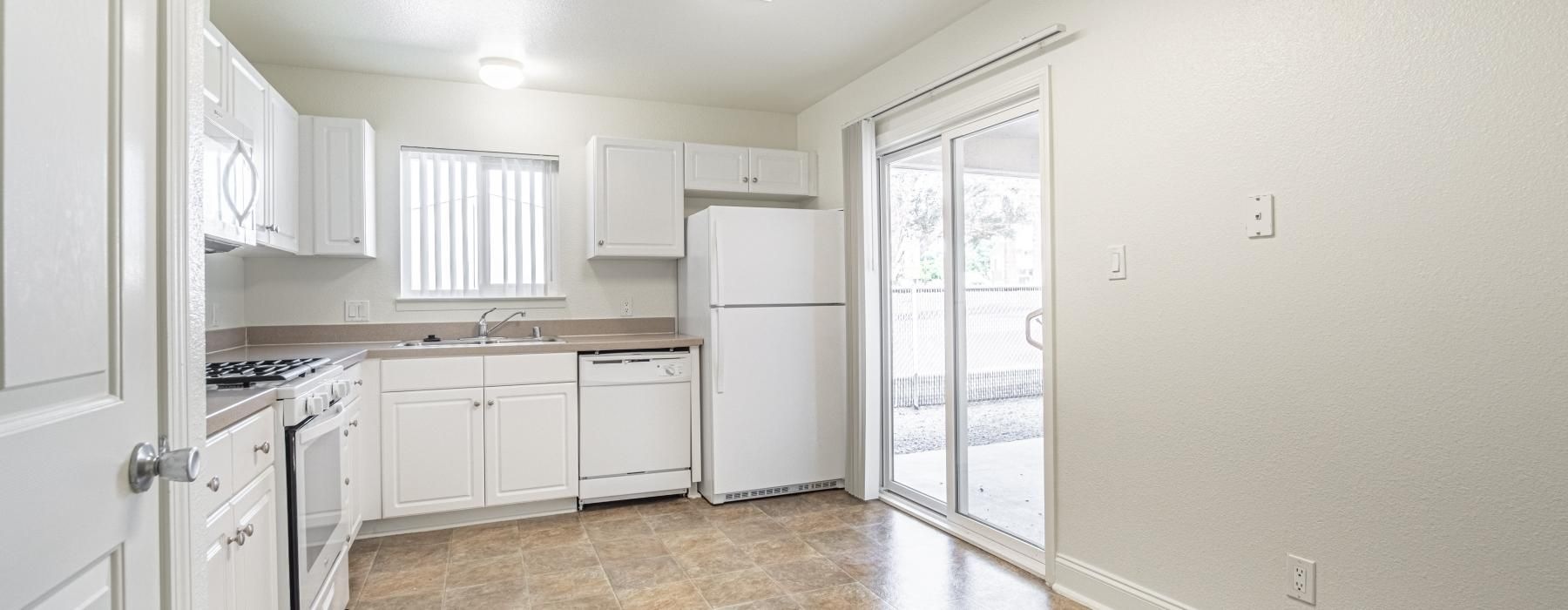 a kitchen with white cabinets