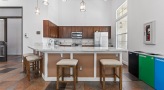 resident kitchen with a bar and chairs