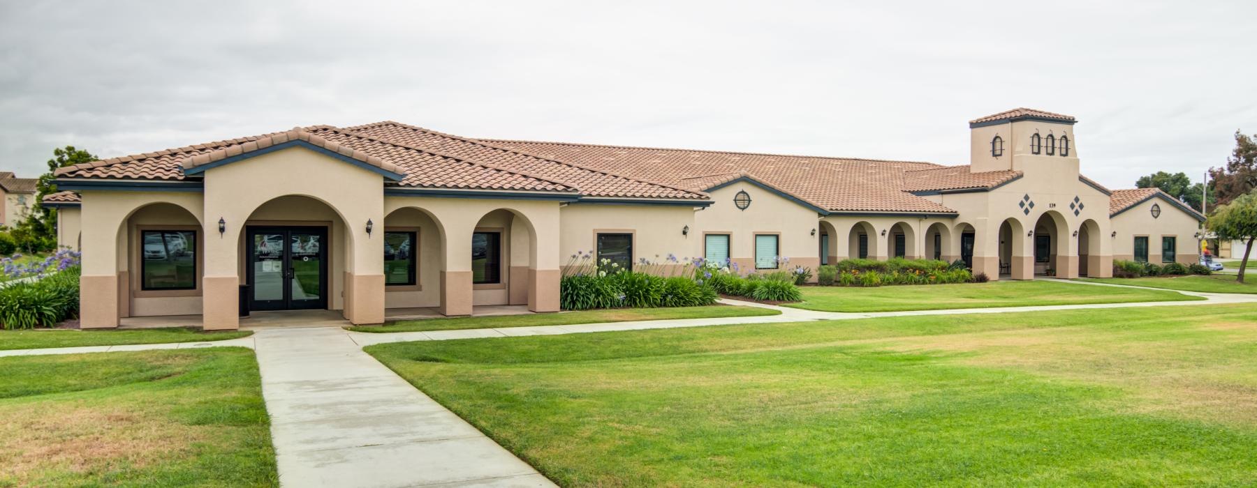 a large building with a lawn in front of it