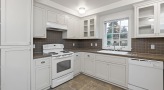 a kitchen with white cabinets