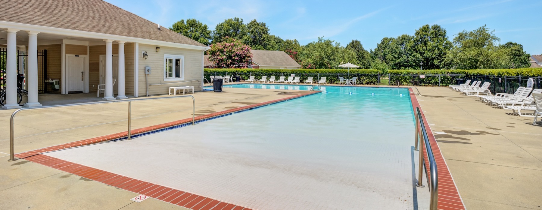 Resort-style swimming pool with lounge seating