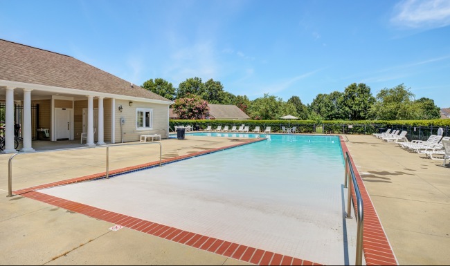 Resort-style swimming pool with lounge seating