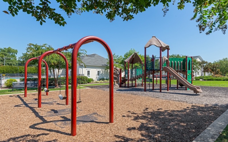 a child's playground with a slide and swings