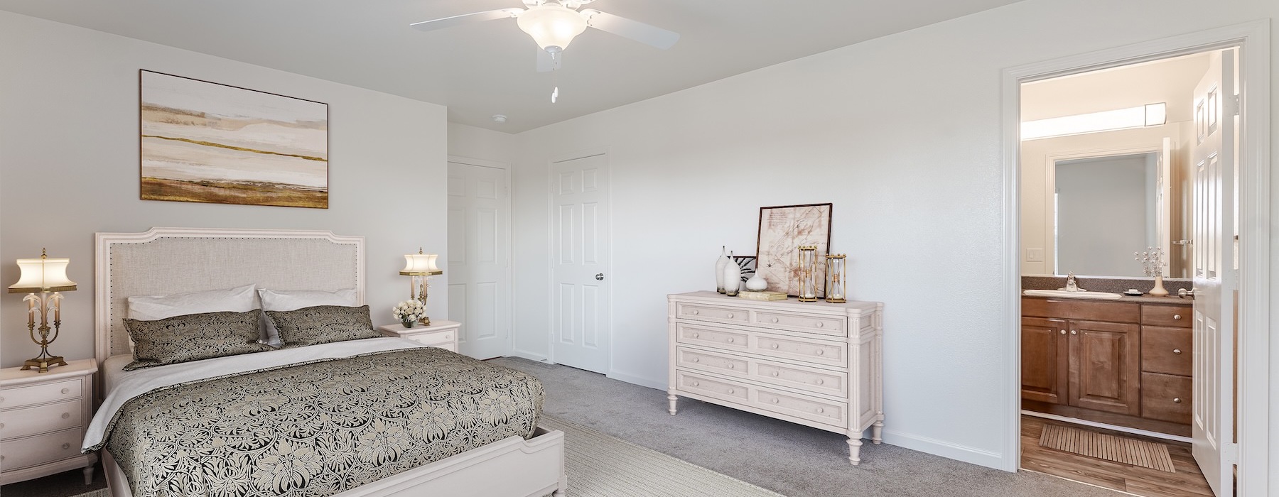 bedroom with bed dresser lamps and bathroom