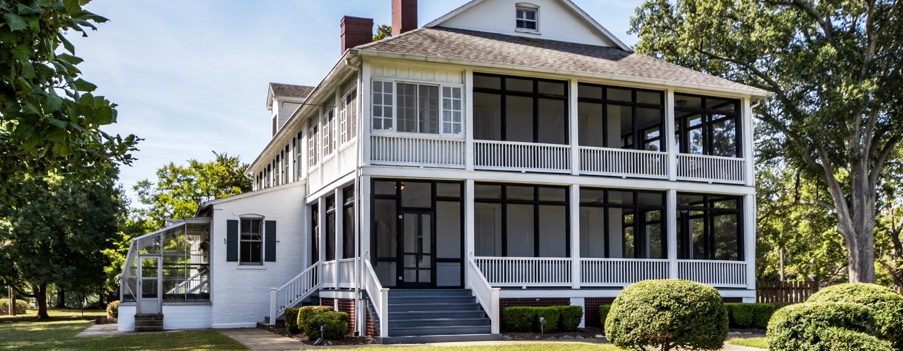 a large house with a lawn in front of it with Harding Home in the background