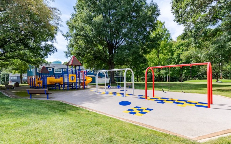 a playground with red and white poles