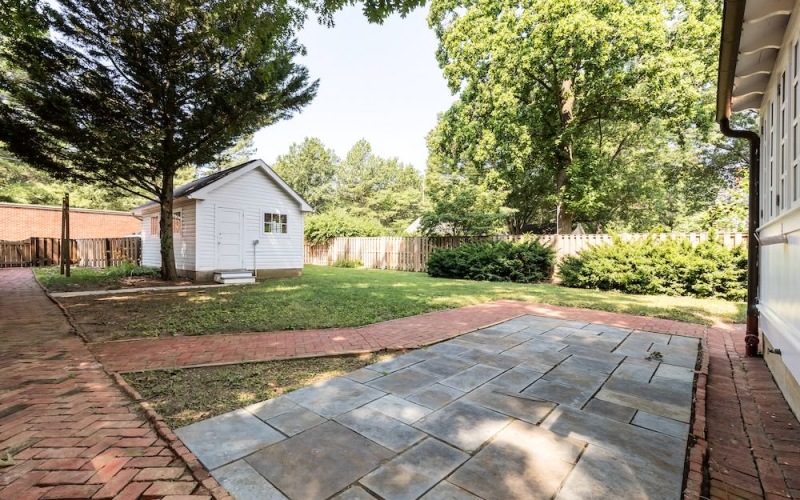fenced in backyard with trees