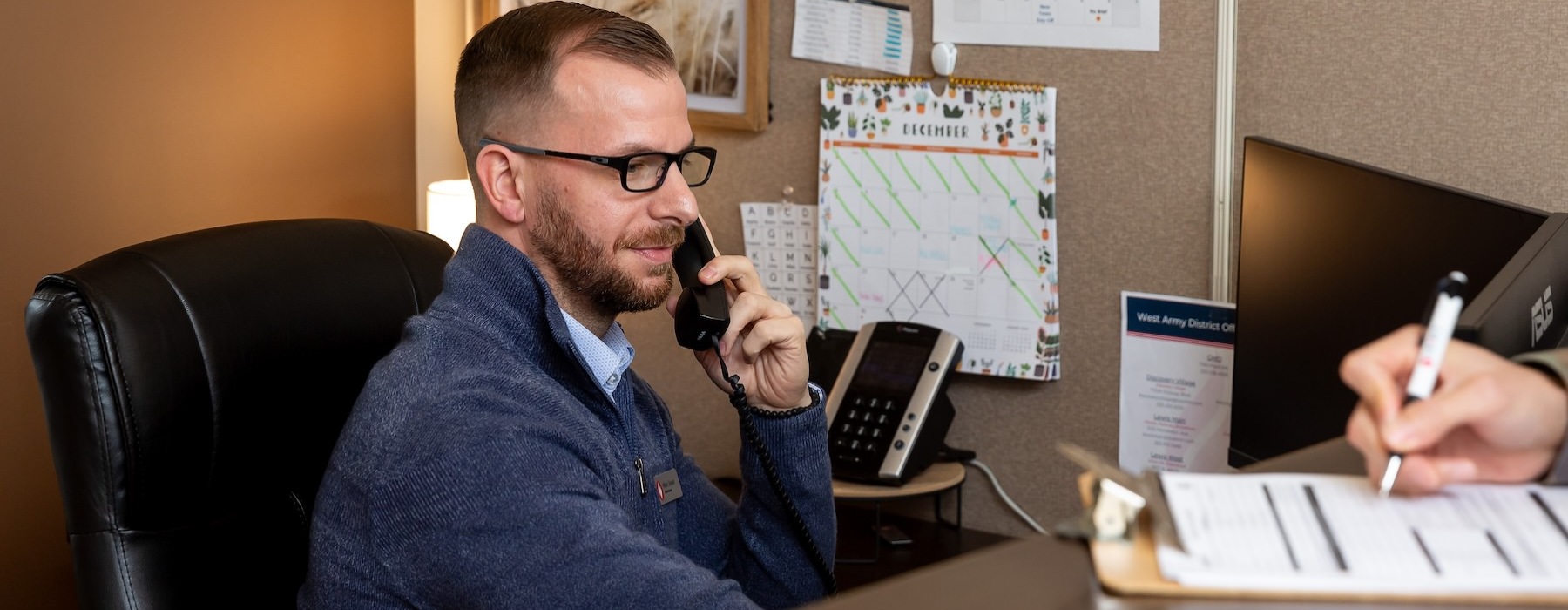 man on the phone at a desk