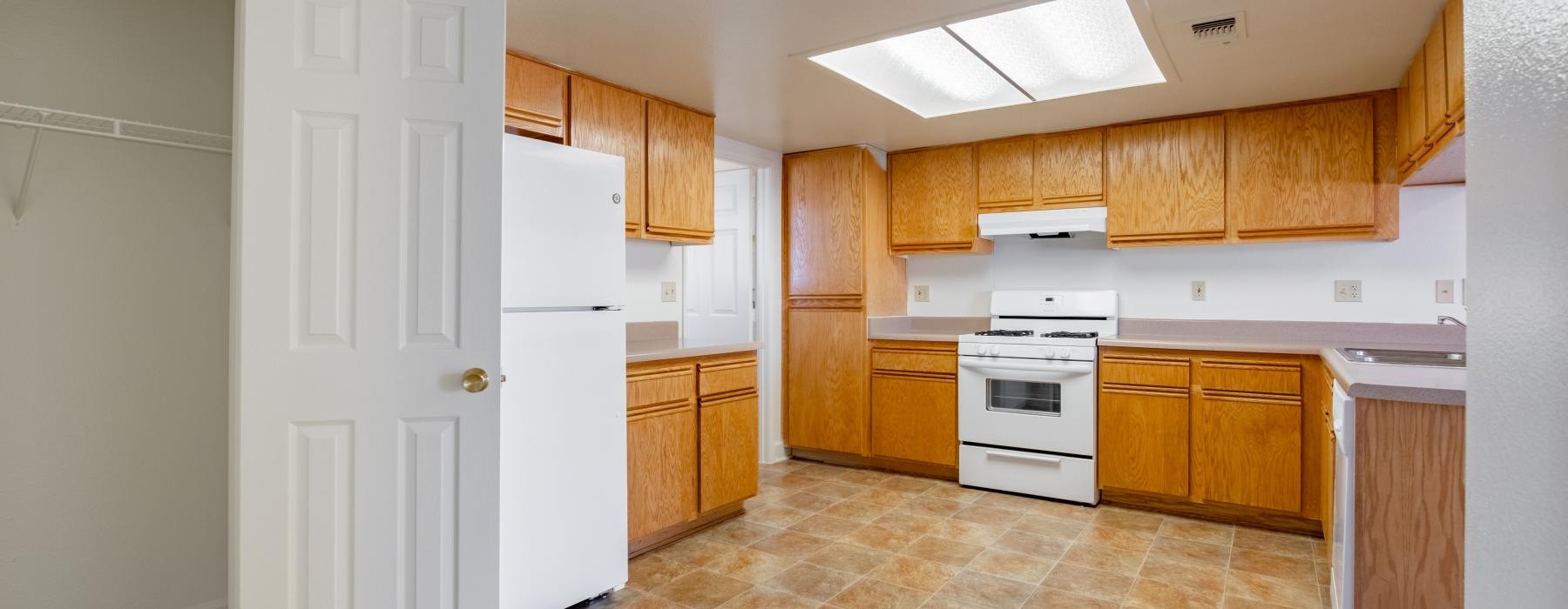 a kitchen with wooden cabinets