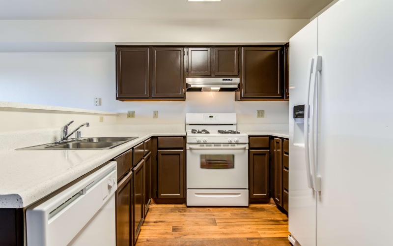 a kitchen with wood cabinets