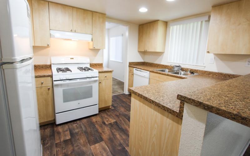 a kitchen with wooden cabinets