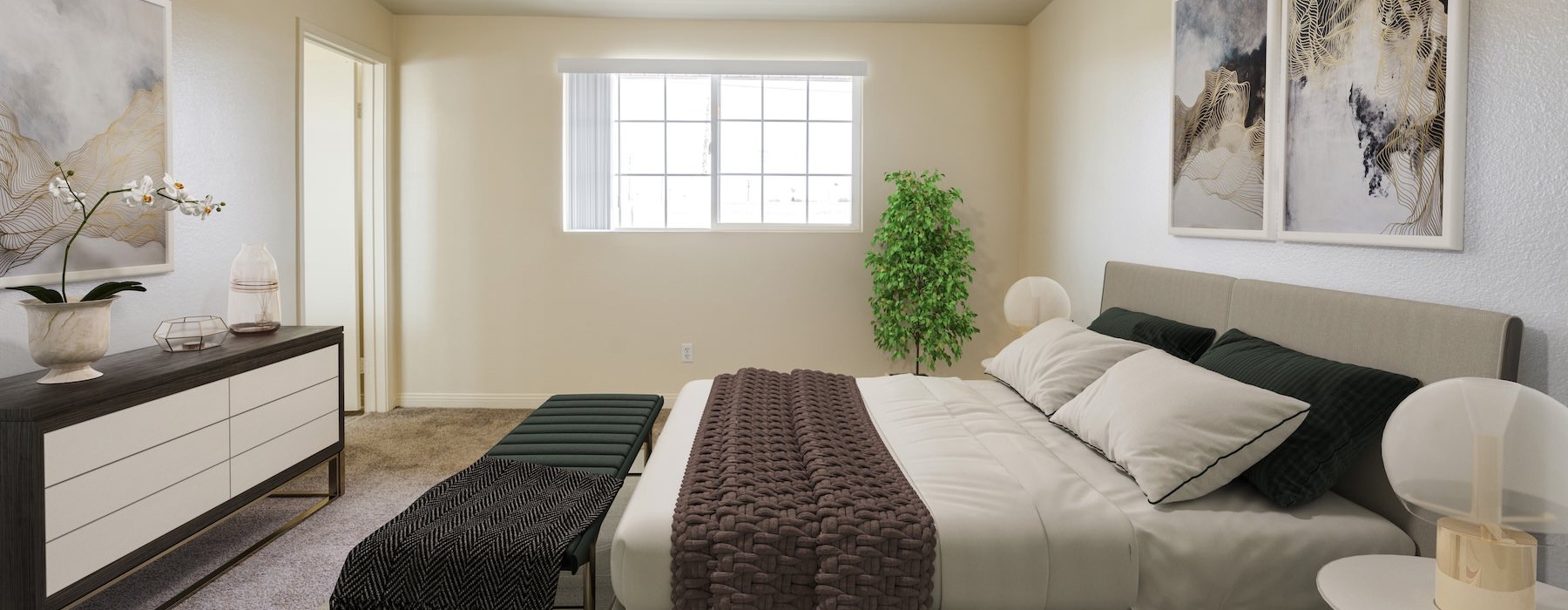 bedroom with a dresser, art on the wall, and large window