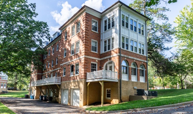 a large building with trees and grass