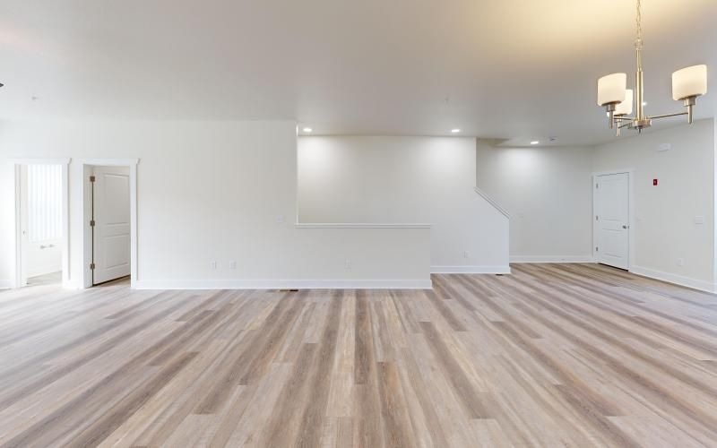 a room with white walls and wood floors