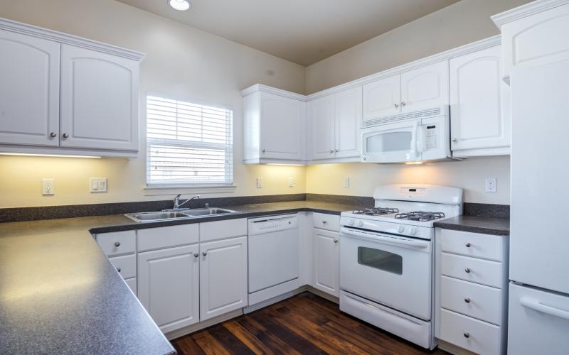 a kitchen with white cabinets