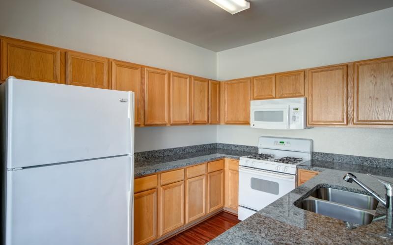 a kitchen with wooden cabinets