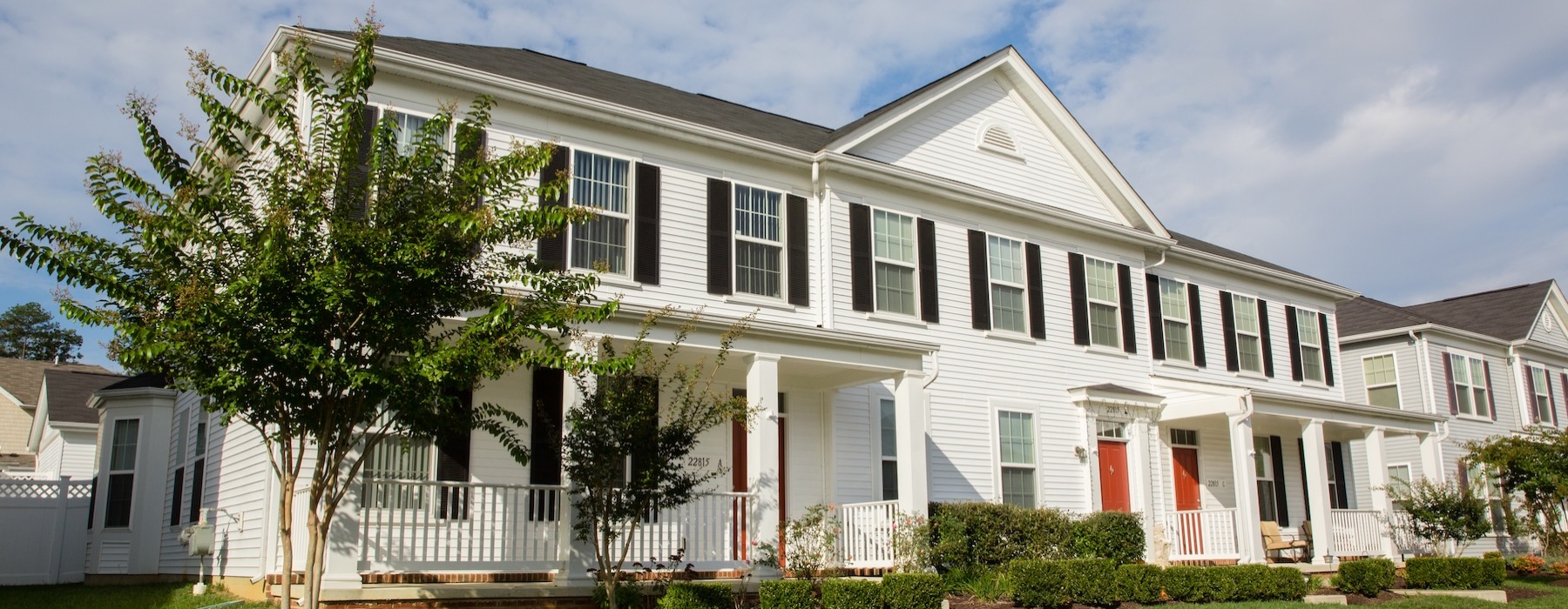 a home with a tree and a lawn